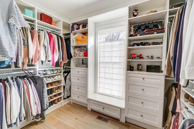 walk in closet featuring light hardwood / wood-style floors