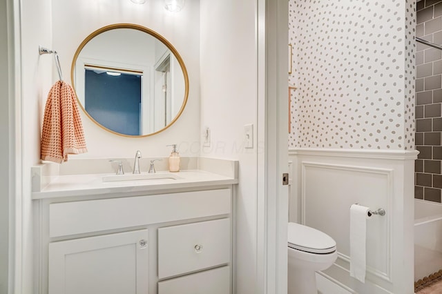 full bathroom with vanity, tiled shower / bath combo, and toilet