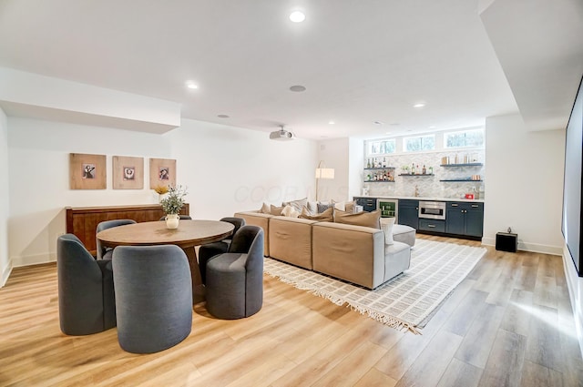 interior space featuring indoor bar and light hardwood / wood-style flooring