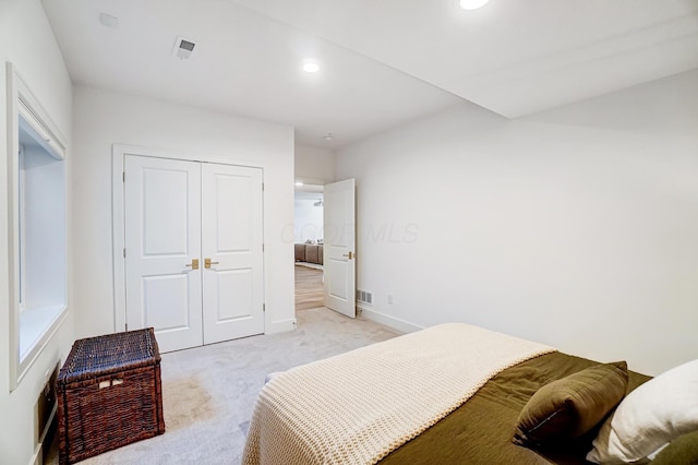 carpeted bedroom with a closet