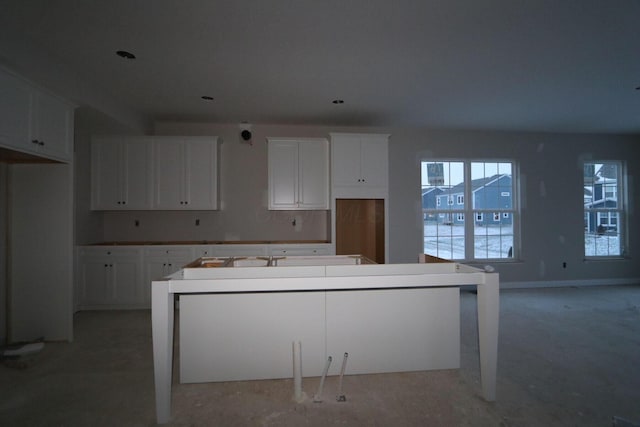 kitchen with white cabinetry and a center island