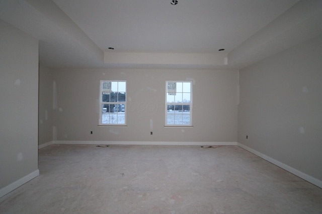 spare room with a raised ceiling