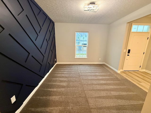 entryway featuring hardwood / wood-style floors and a textured ceiling