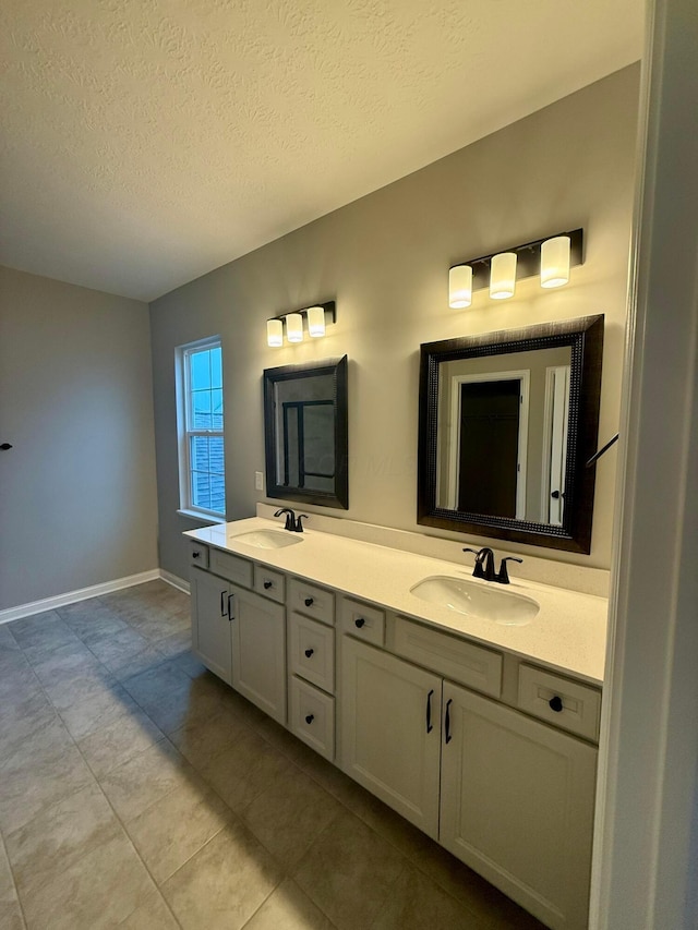 bathroom with vanity and a textured ceiling