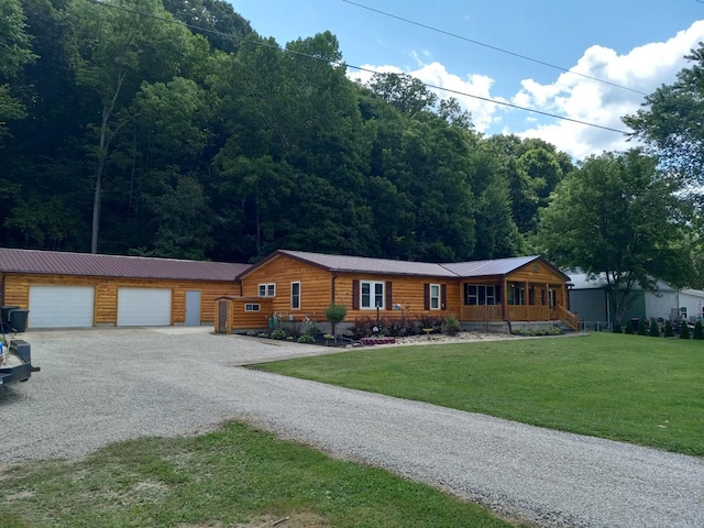 view of front of property with a garage, a front yard, and covered porch