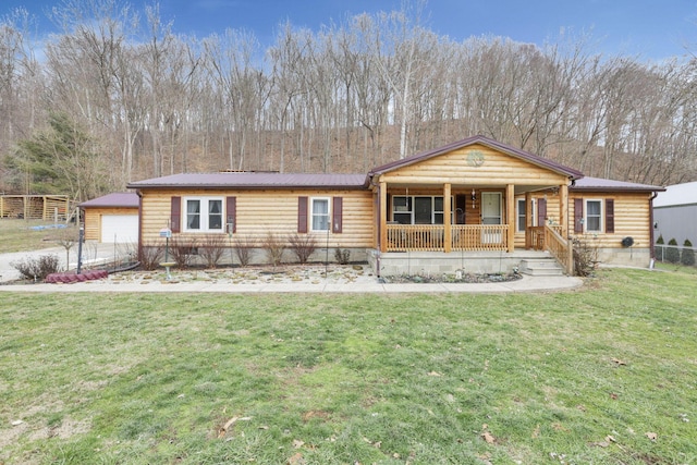 view of front of house with a porch, a garage, and a front lawn