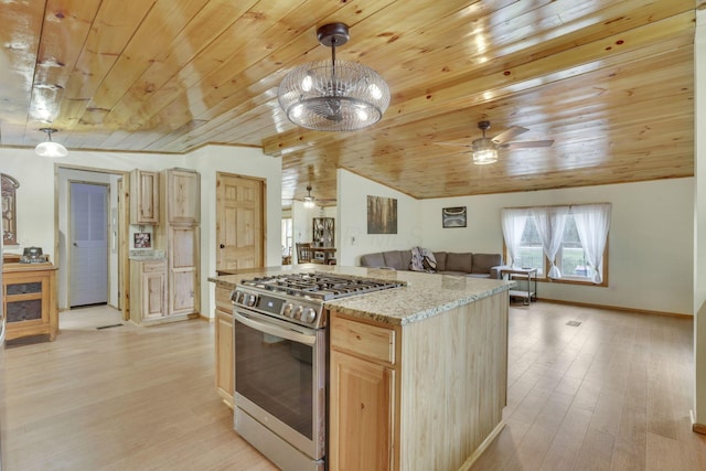 kitchen with stainless steel range with gas cooktop, pendant lighting, light brown cabinetry, and light hardwood / wood-style flooring