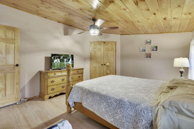 bedroom featuring wood ceiling, ceiling fan, a closet, and light wood-type flooring