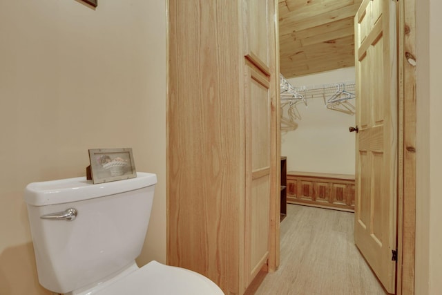 bathroom featuring wood-type flooring and toilet