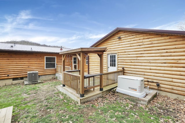 rear view of house featuring central AC and a deck