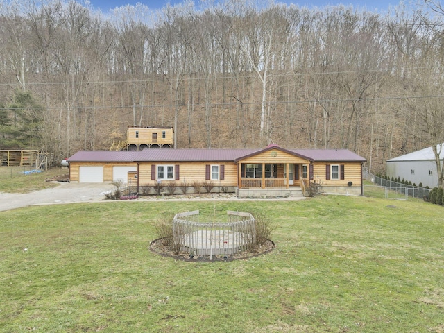 view of front facade with a garage, a front yard, and covered porch