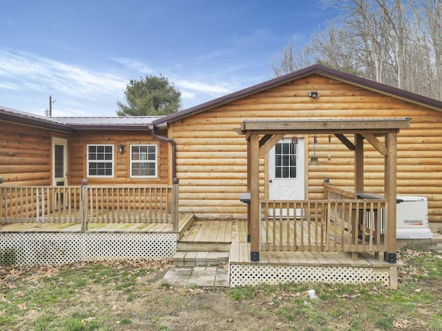 rear view of property featuring a wooden deck