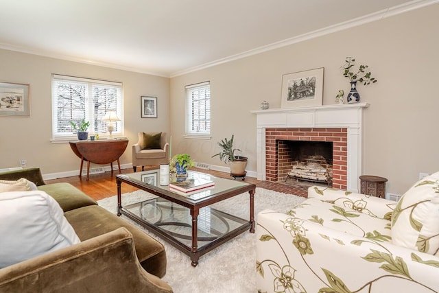 living area with a fireplace, crown molding, baseboards, and wood finished floors