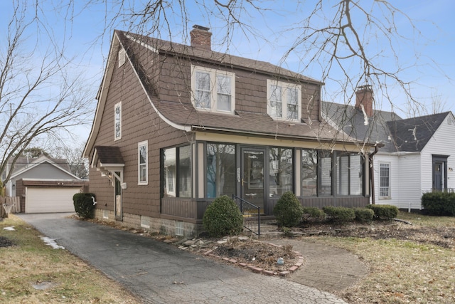 view of front facade with a garage and an outbuilding