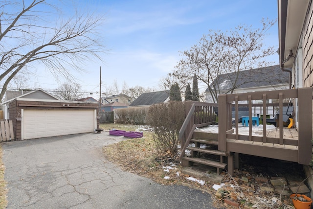 view of yard with a garage, an outdoor structure, and a deck