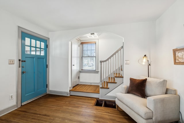 entryway with a healthy amount of sunlight and dark wood-type flooring