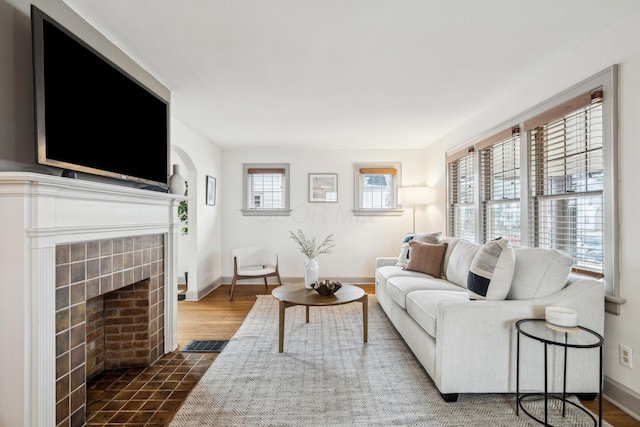 living room with dark hardwood / wood-style floors and a fireplace