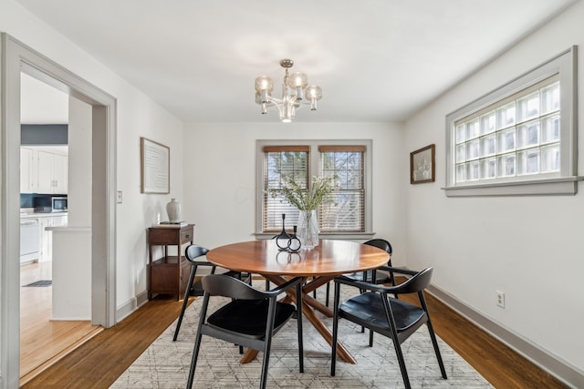 dining room featuring a notable chandelier and dark hardwood / wood-style floors