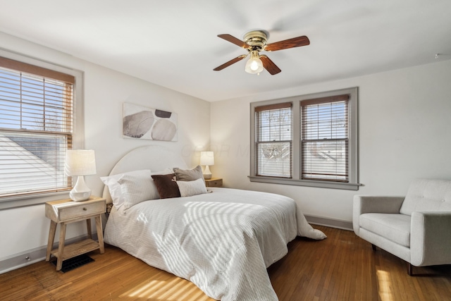 bedroom with ceiling fan and dark hardwood / wood-style flooring