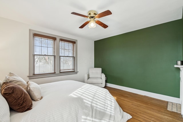 bedroom featuring hardwood / wood-style flooring and ceiling fan