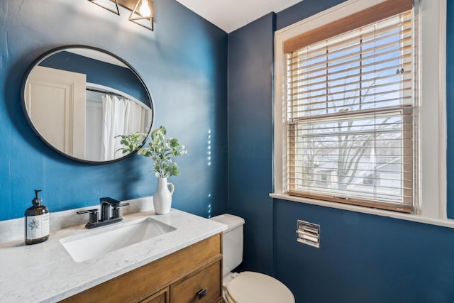 bathroom featuring vanity and toilet