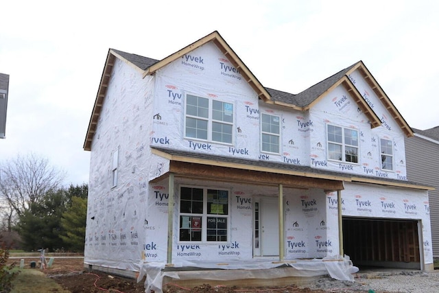 property in mid-construction with a porch and a garage