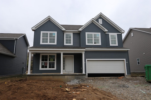 view of front facade featuring a porch, a garage, roof with shingles, and board and batten siding