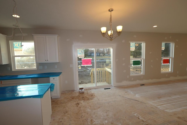 kitchen featuring an inviting chandelier, white cabinetry, and decorative light fixtures