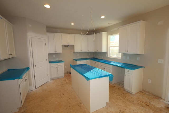 kitchen featuring recessed lighting, a kitchen island, and white cabinets