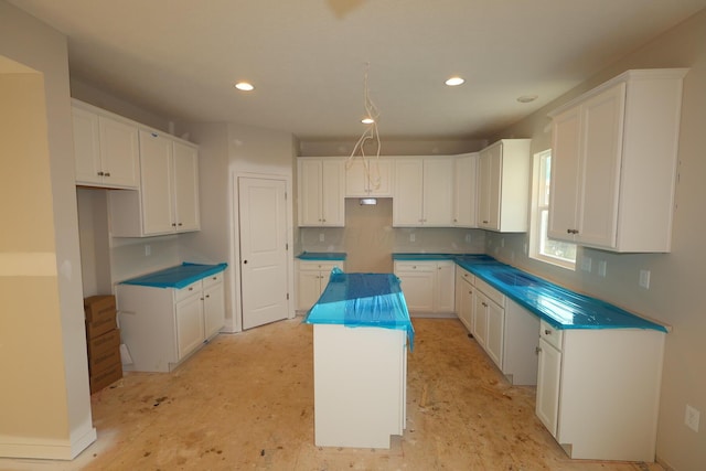 kitchen featuring recessed lighting, decorative backsplash, white cabinets, and a center island