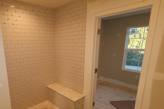 full bath with a tile shower