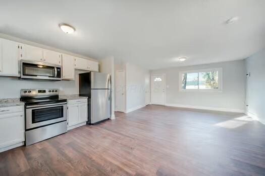 kitchen featuring light hardwood / wood-style floors, white cabinets, and appliances with stainless steel finishes