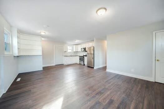 unfurnished living room featuring dark wood-type flooring