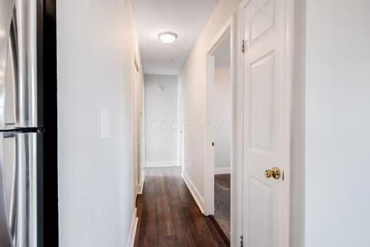 hall with dark hardwood / wood-style flooring