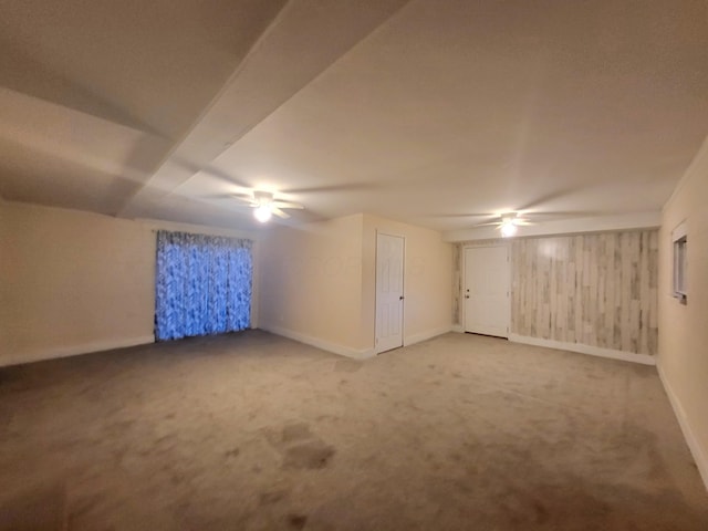 bonus room with ceiling fan and carpet flooring