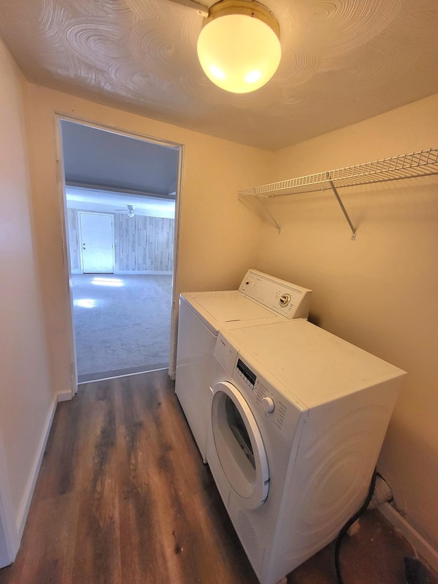 laundry room with washing machine and clothes dryer and dark hardwood / wood-style flooring