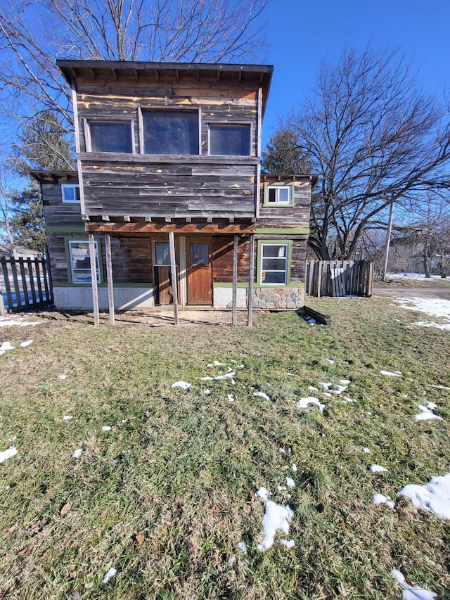 rear view of property featuring a yard