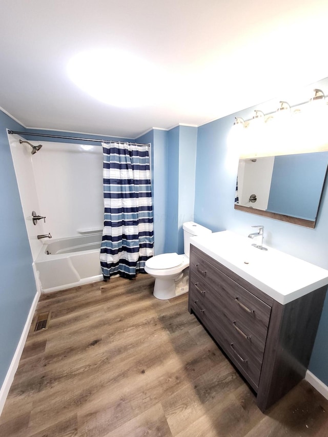 full bathroom with hardwood / wood-style flooring, vanity, toilet, and shower / tub combo