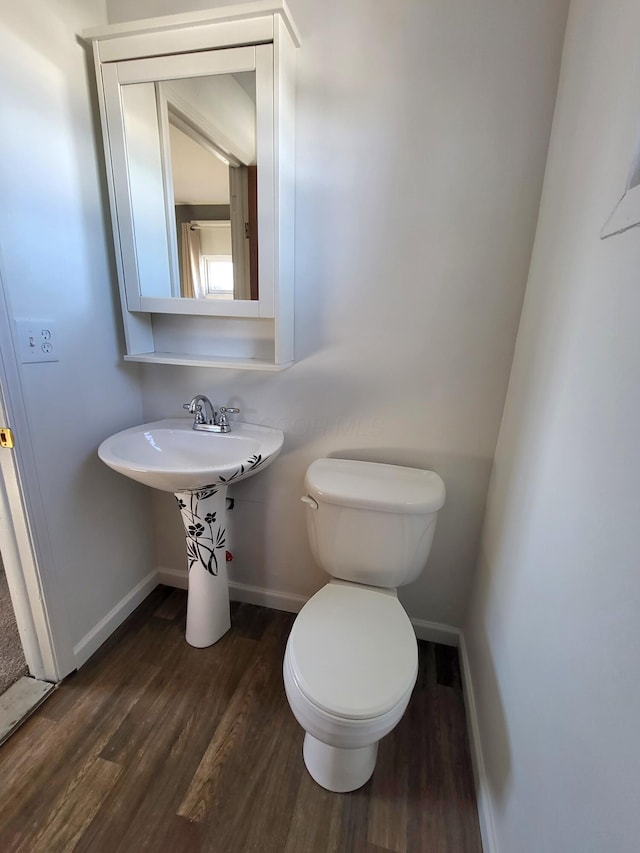 bathroom with wood-type flooring and toilet