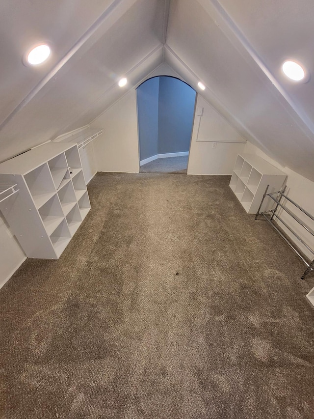 bonus room featuring carpet flooring and vaulted ceiling