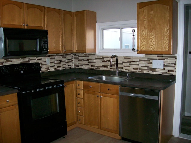 kitchen featuring tasteful backsplash, sink, and black appliances