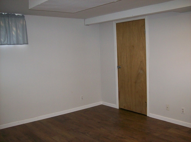 basement with dark hardwood / wood-style floors