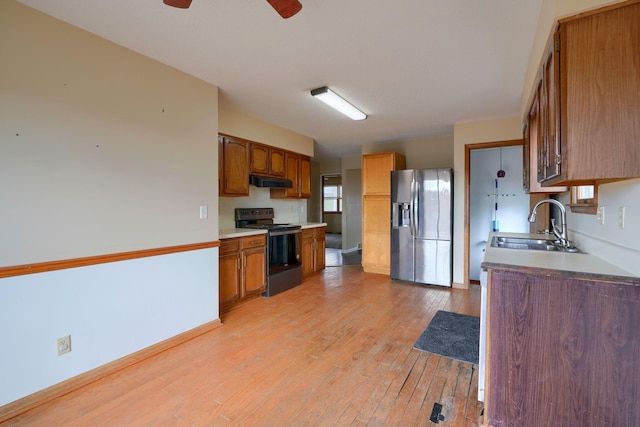 kitchen with sink, stainless steel fridge with ice dispenser, light wood-type flooring, ceiling fan, and black range with electric stovetop