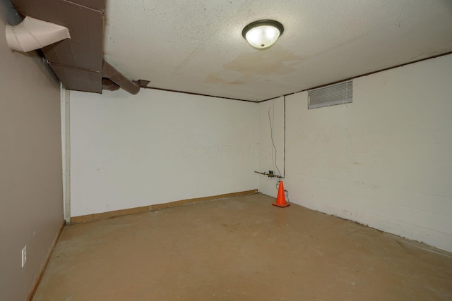 basement featuring a textured ceiling