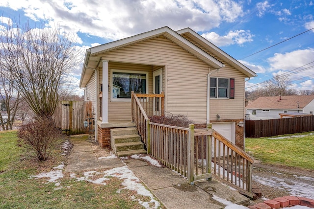 bungalow with a garage and a front yard