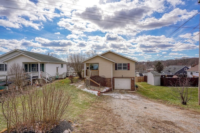 view of front of property with a garage and a storage unit