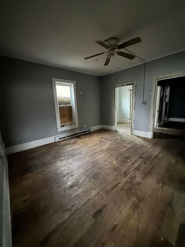 spare room with a baseboard heating unit, wood-type flooring, and ceiling fan