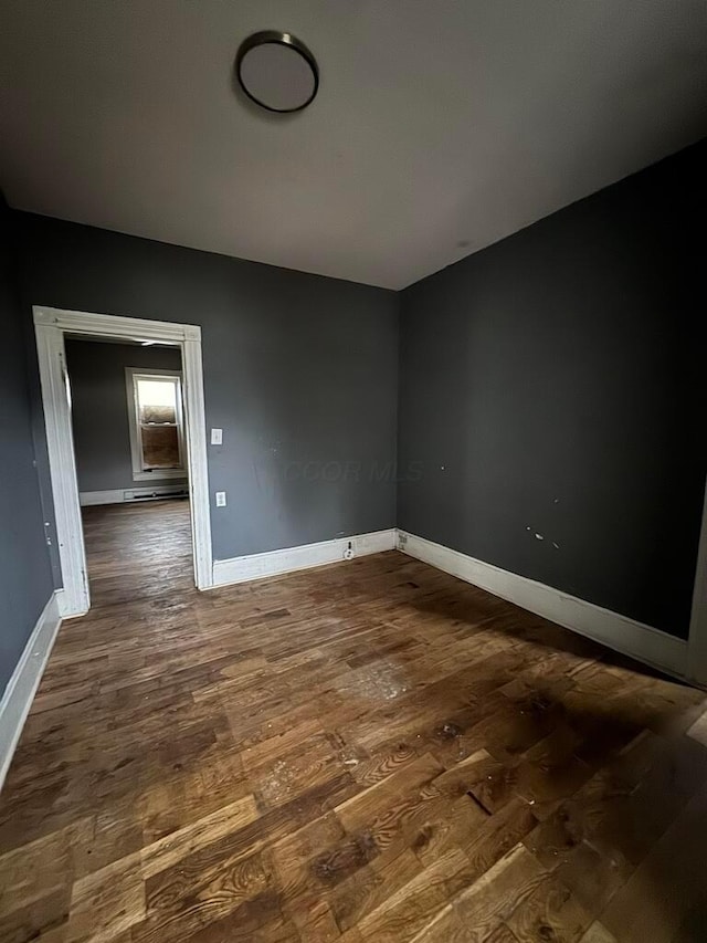 spare room with dark wood-type flooring