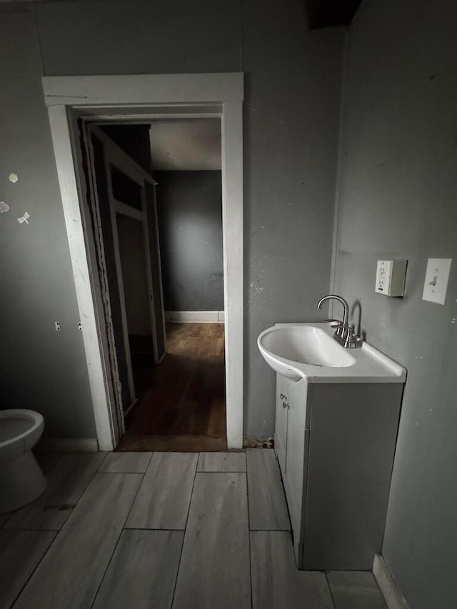 bathroom featuring vanity, hardwood / wood-style floors, and toilet