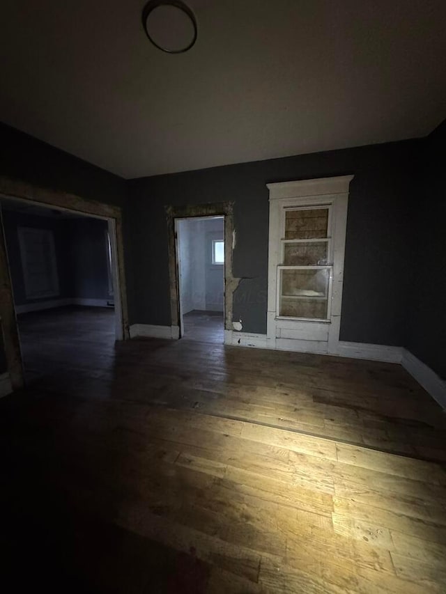 spare room with dark hardwood / wood-style flooring